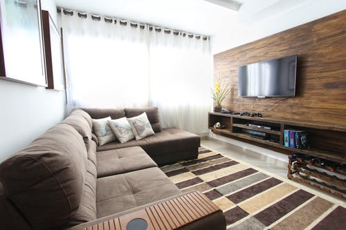 Homepage: Basement Renovation Picture: beige couch facing tv with panelled wall